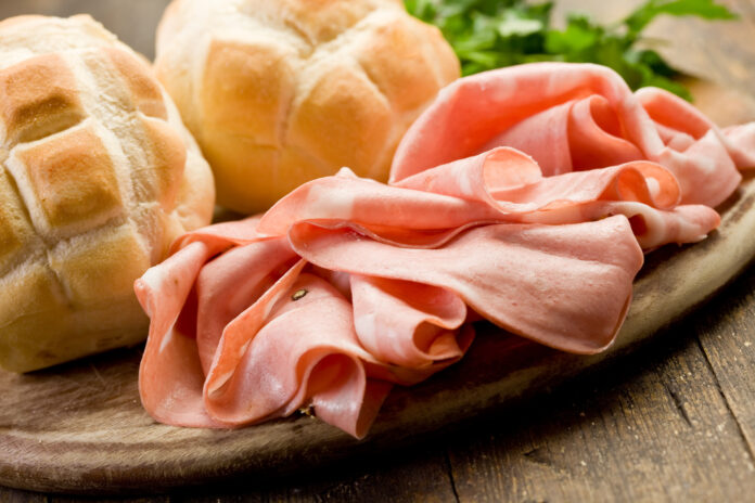 Mortadella with Bread on Chopping board
